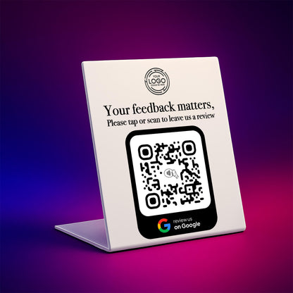 a white sign with a QR code on it, placed on a purple background.