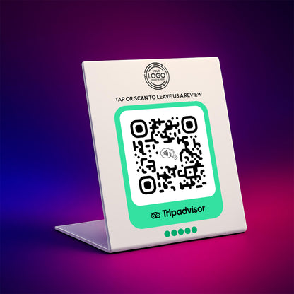 a white sign with a QR code on it, placed on a laptop.