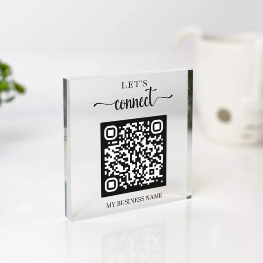 a clear block with a QR code on it, along with the text "Let's connect" and "MY BUSINESS NAME" printed on it.