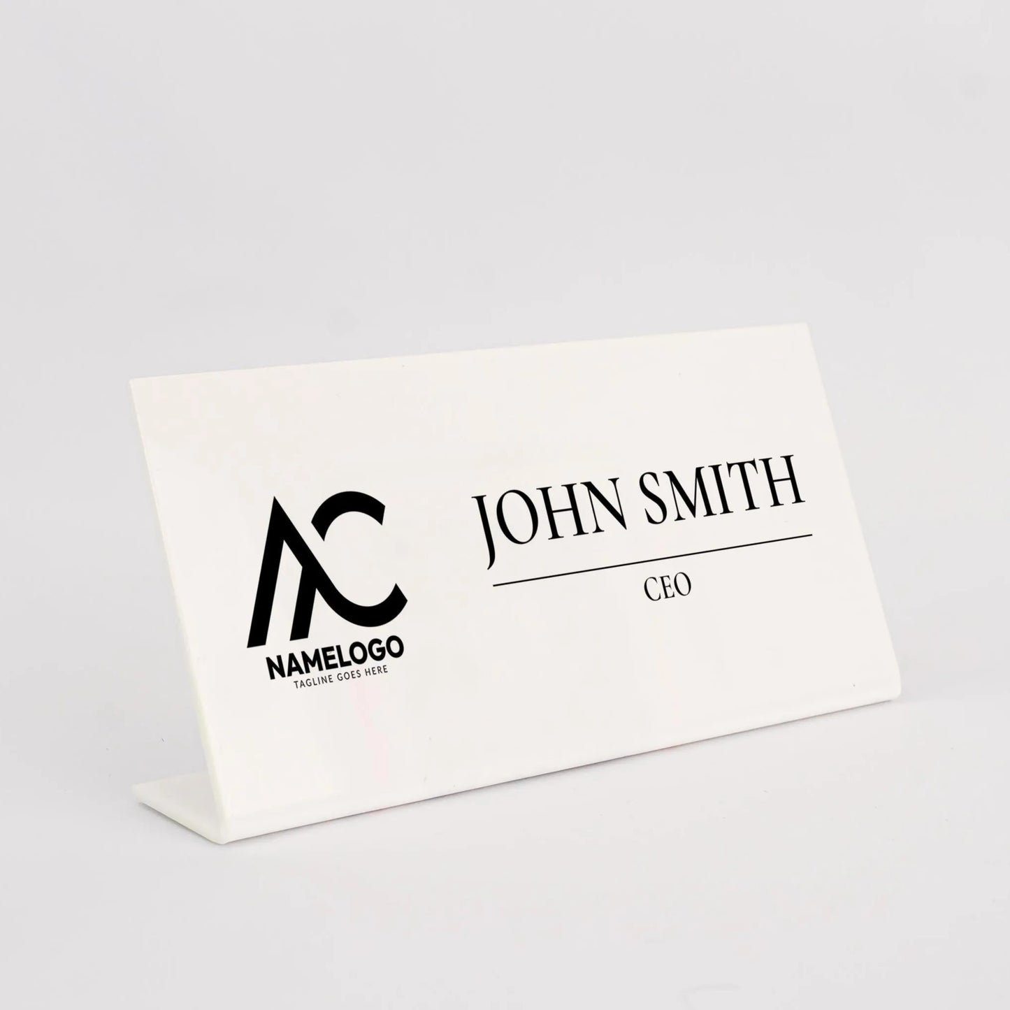 A white nameplate with the name 'John Smith' and the title 'CEO' printed on it.