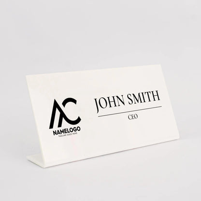 A white nameplate with the name 'John Smith' and the title 'CEO' printed on it.