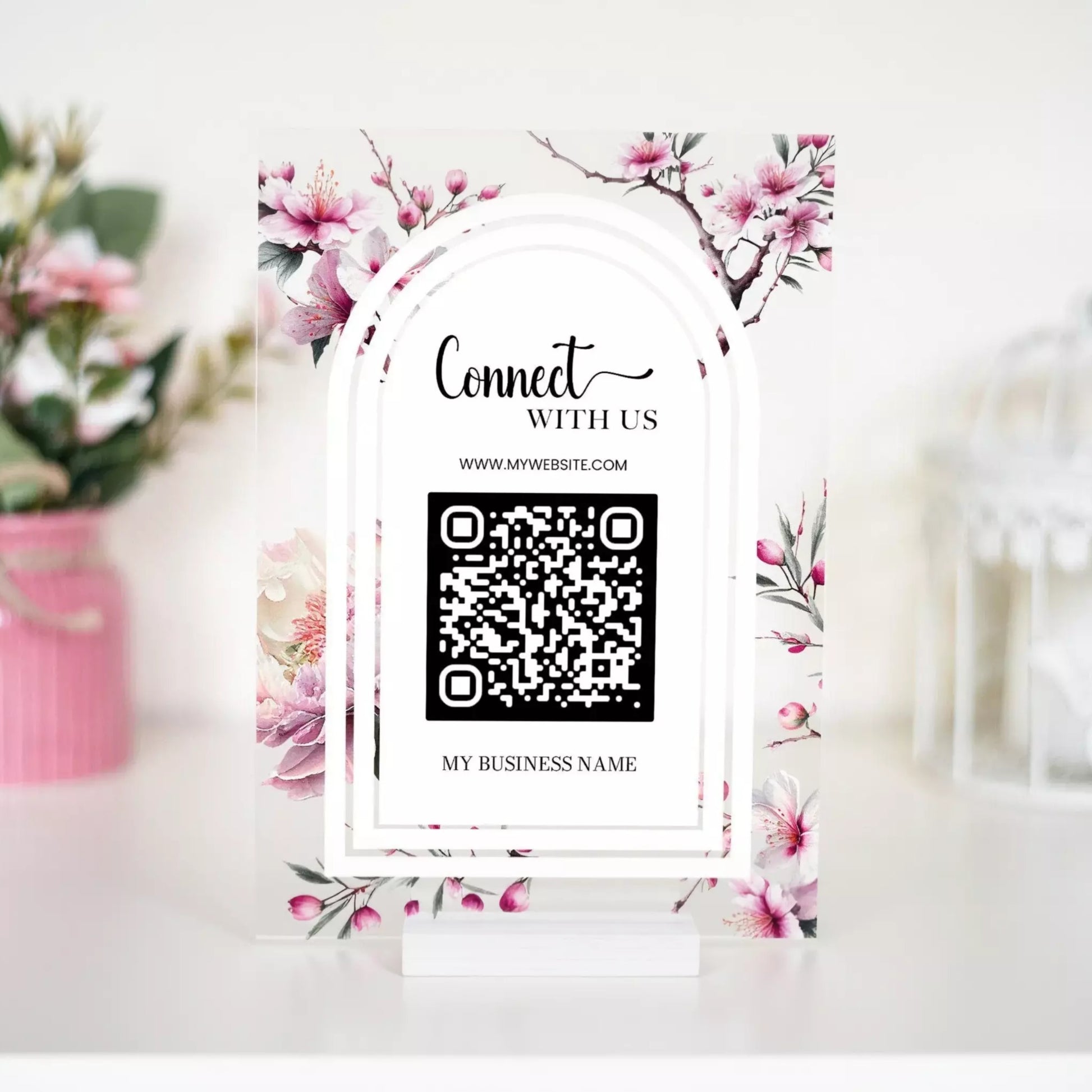a business card holder with a floral design and a QR code.
