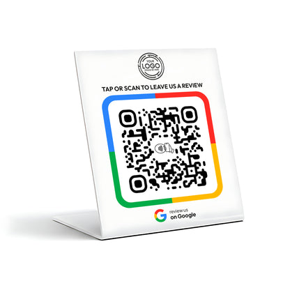 a QR code on a stand, which is a type of digital payment method. The QR code is accompanied by a message that reads "TAP OR SCAN TO LEAVE US A REVIEW" and a logo for Google.
