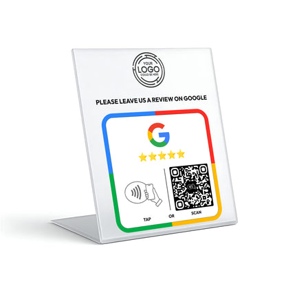 The image is a sign with instructions for leaving a review on Google. It includes a Google logo, a QR code, and a button for either tapping or scanning. The sign is placed on a stand, and there is a QR code visible.