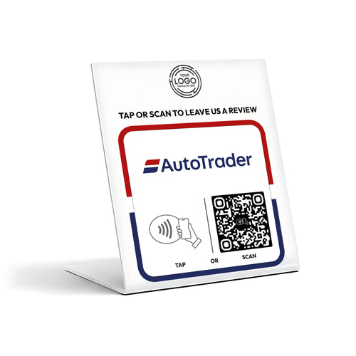 a sign for an AutoTrader app, which allows users to tap or scan to leave a review.